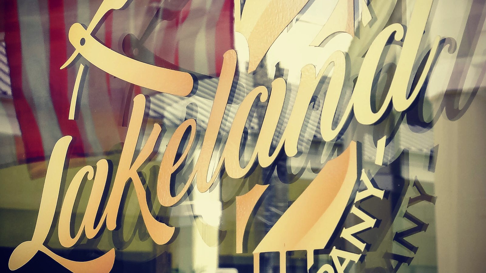 Gold script lettering painted across the shop's front window